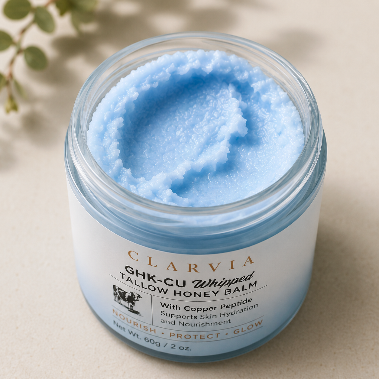 Clarvia Restoration Balm jar with lid off, showing the balm inside.